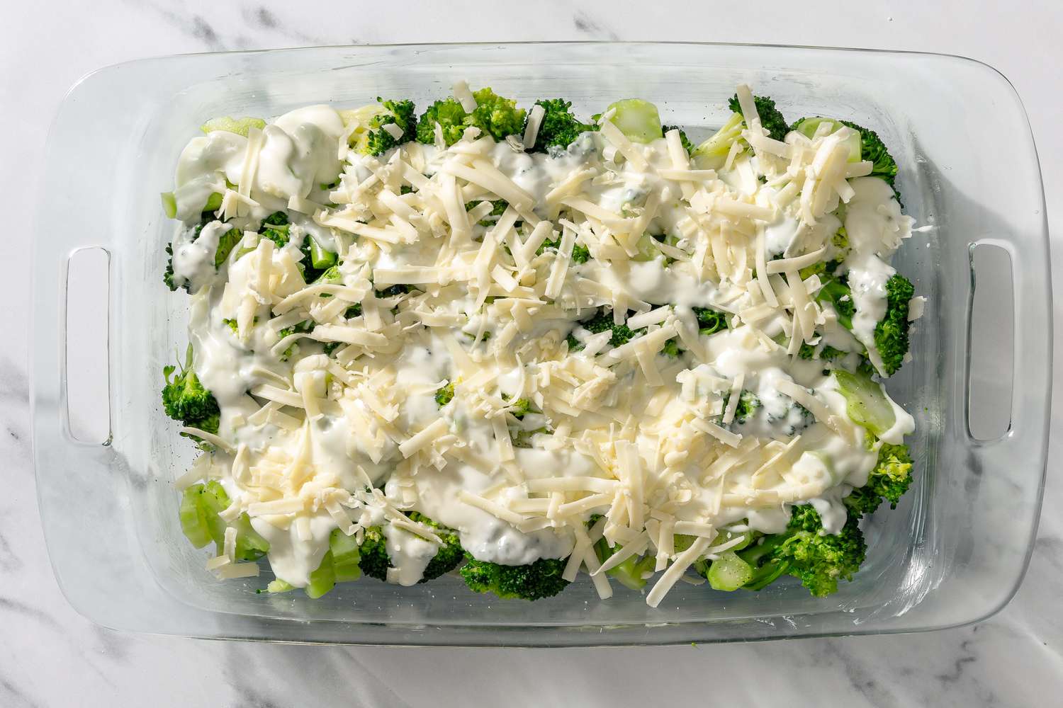 cheese added to casserole mixture in dish for My Mom’s Famous Broccoli Cheese Casserole