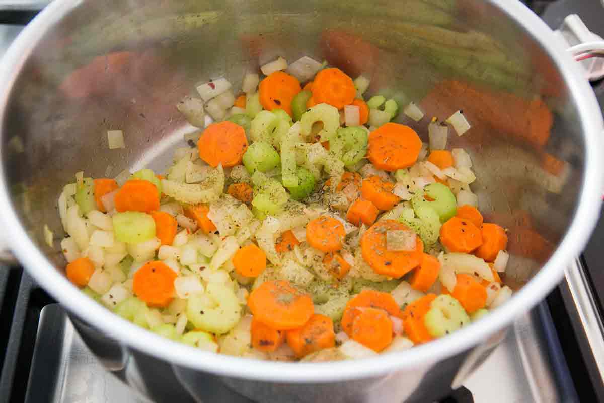 add seasonings to the vegetables for the base of easy chicken soup