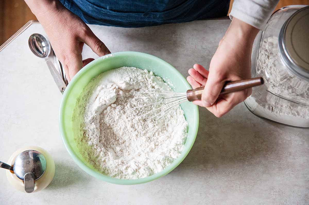 Mixing dry ingredients for pancake mix with a whisk in a mixing bowl
