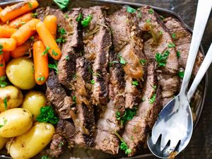 Instant Pot Pot Roast sliced and served on a platter with carrots and potatoes