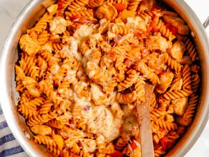 One-Pan Chicken Fajita Pasta in a pot with a wooden spoon
