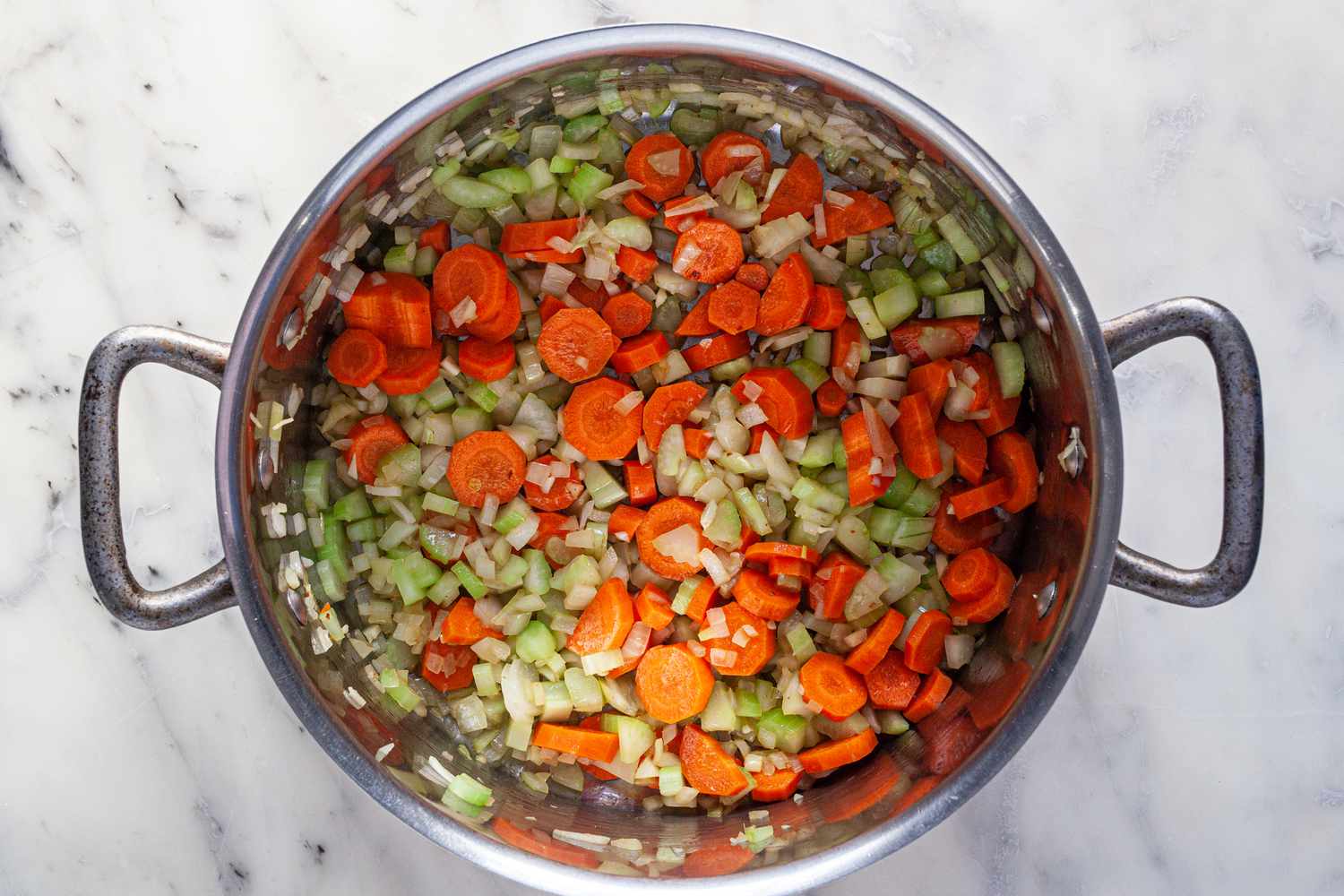 Cooking mirepoix in a pot to make the best Manhattan Clam Chowder recipe