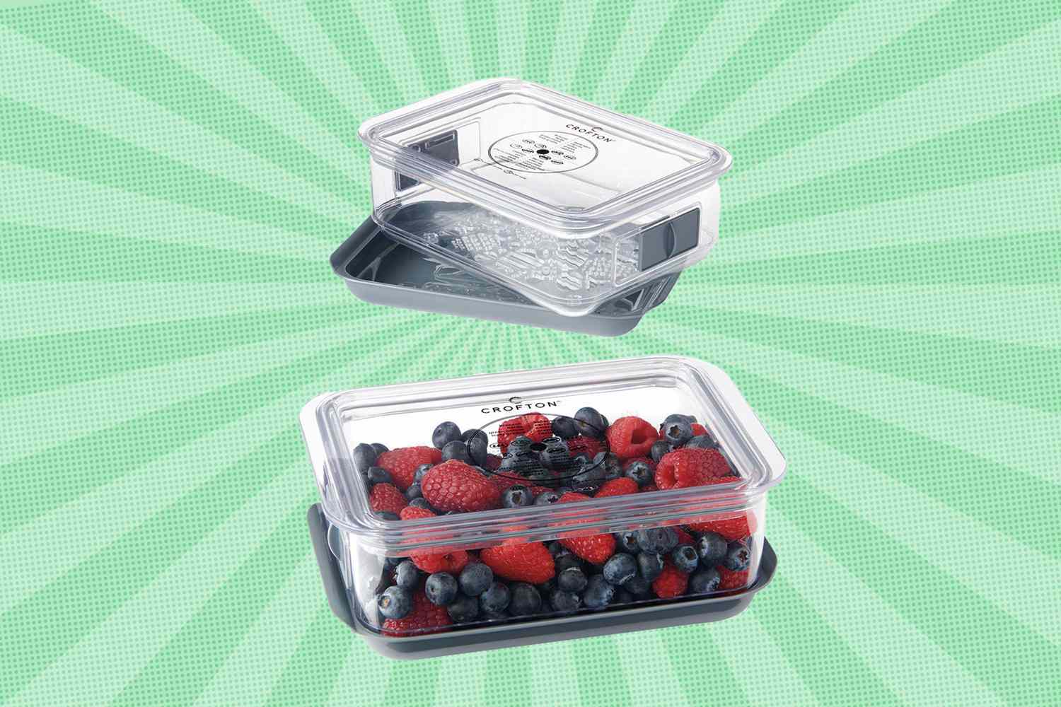 Two clear plastic containers for storing berries one filled with blueberries and raspberries