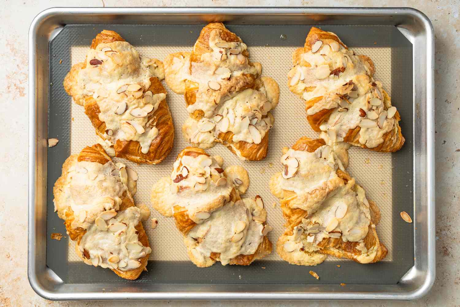 Almond Croissants Resting on the Lined Baking Pan After Baked 