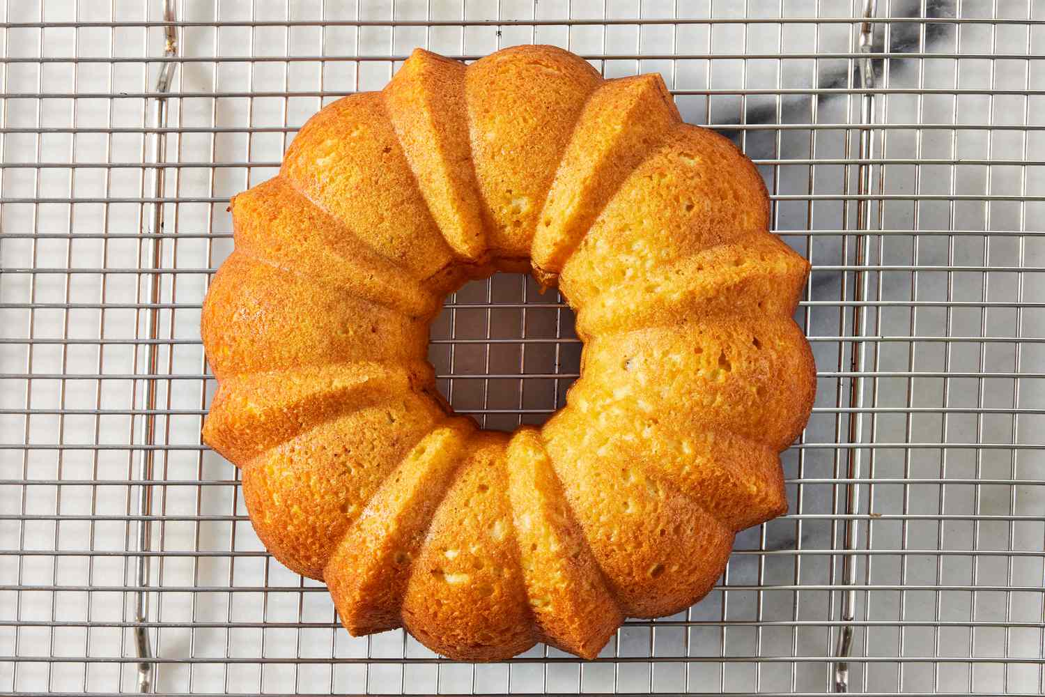 baked cake cooling on a cooling rack for Sock It to Me Cake