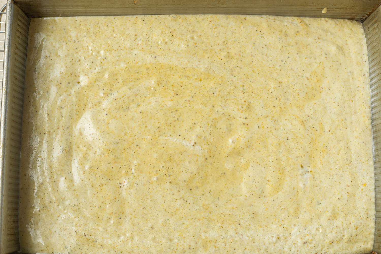 Pistachio Cardamom Tres Leches Cake Batter in Cake Tray