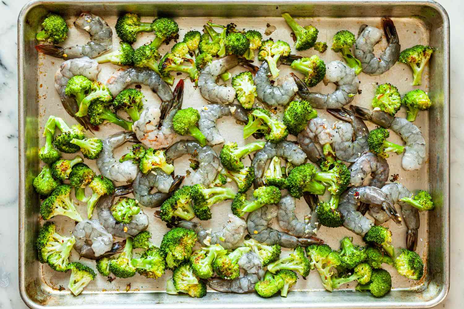 Roasted broccoli on a sheet pan to make Sheet Pan Hot Honey Roasted Shrimp and Broccoli.