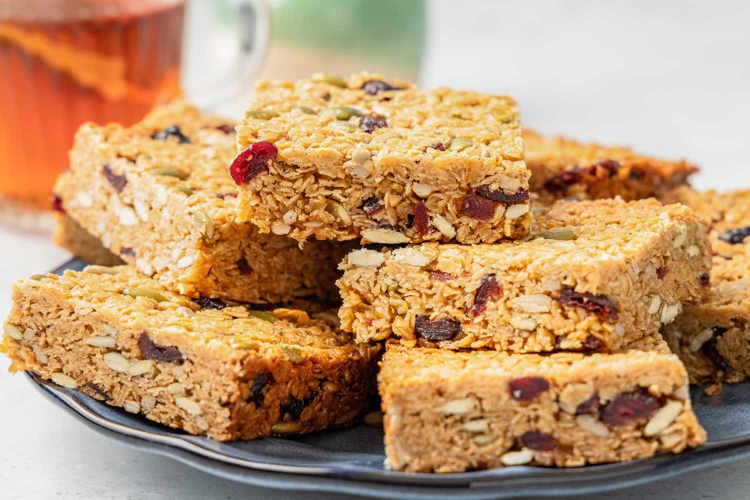 Sliced Flapjacks on a Plate Next to a Glass of Tea