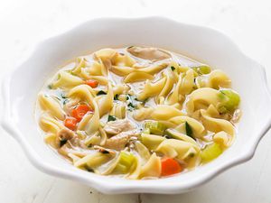 Easy chicken noodle soup in a white bowl.