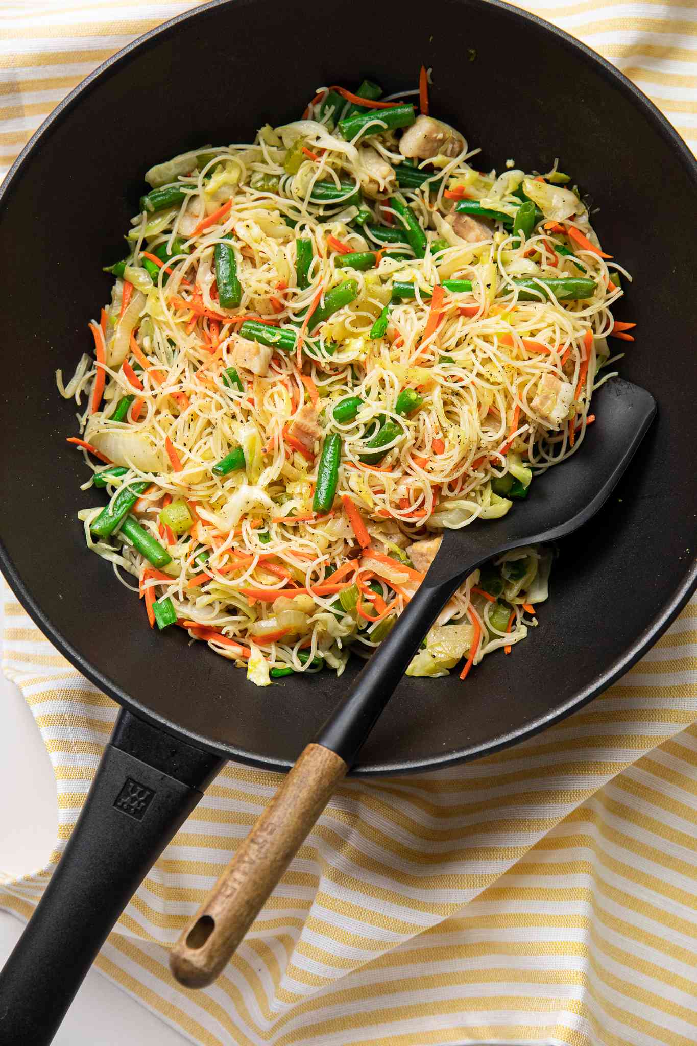 Pancit Bihon (Filipino Rice Noodles) in a Wok with a Spatula