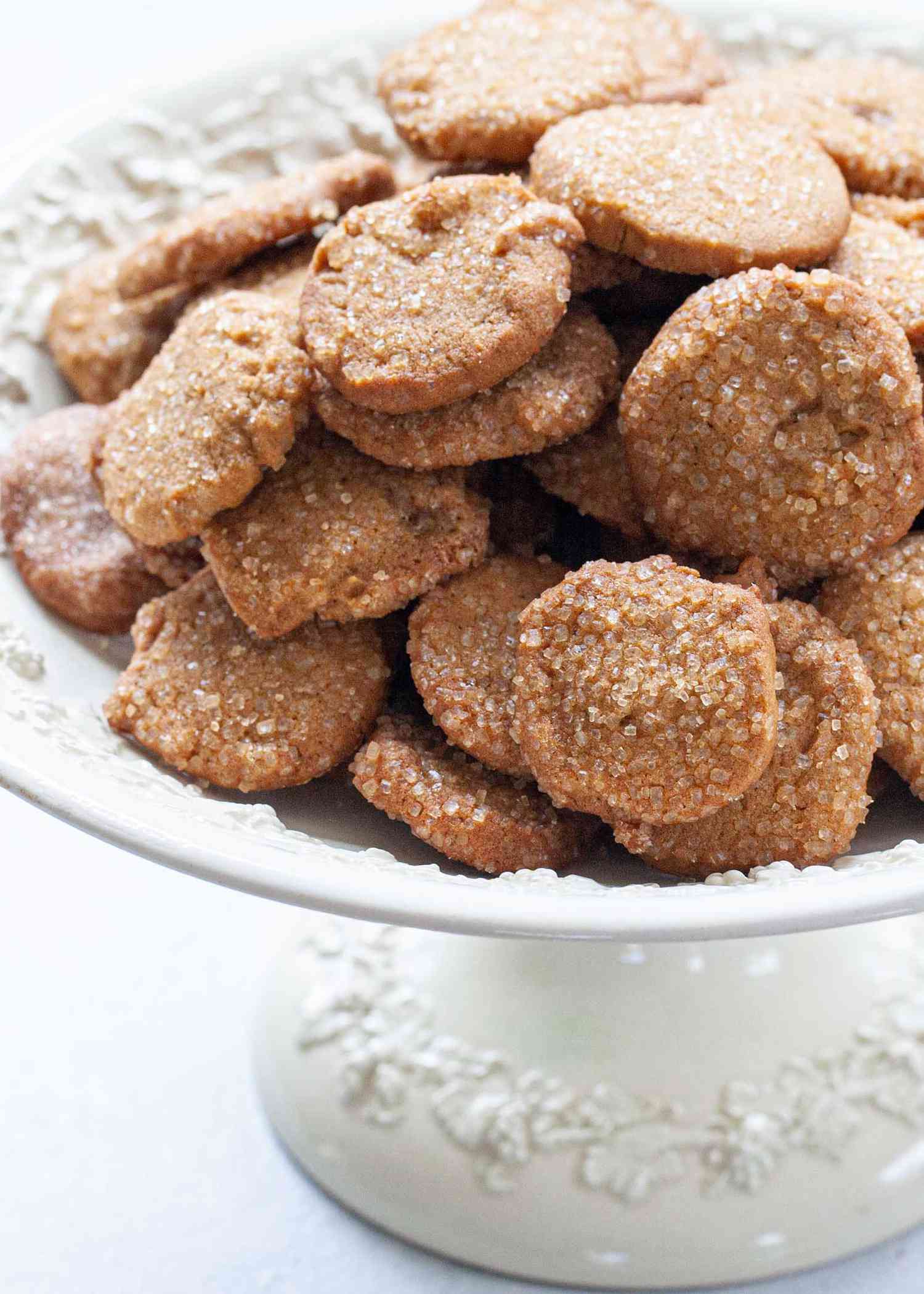 A footed serving bowl with Easy Ginger Lemon Cookies stacked on top.