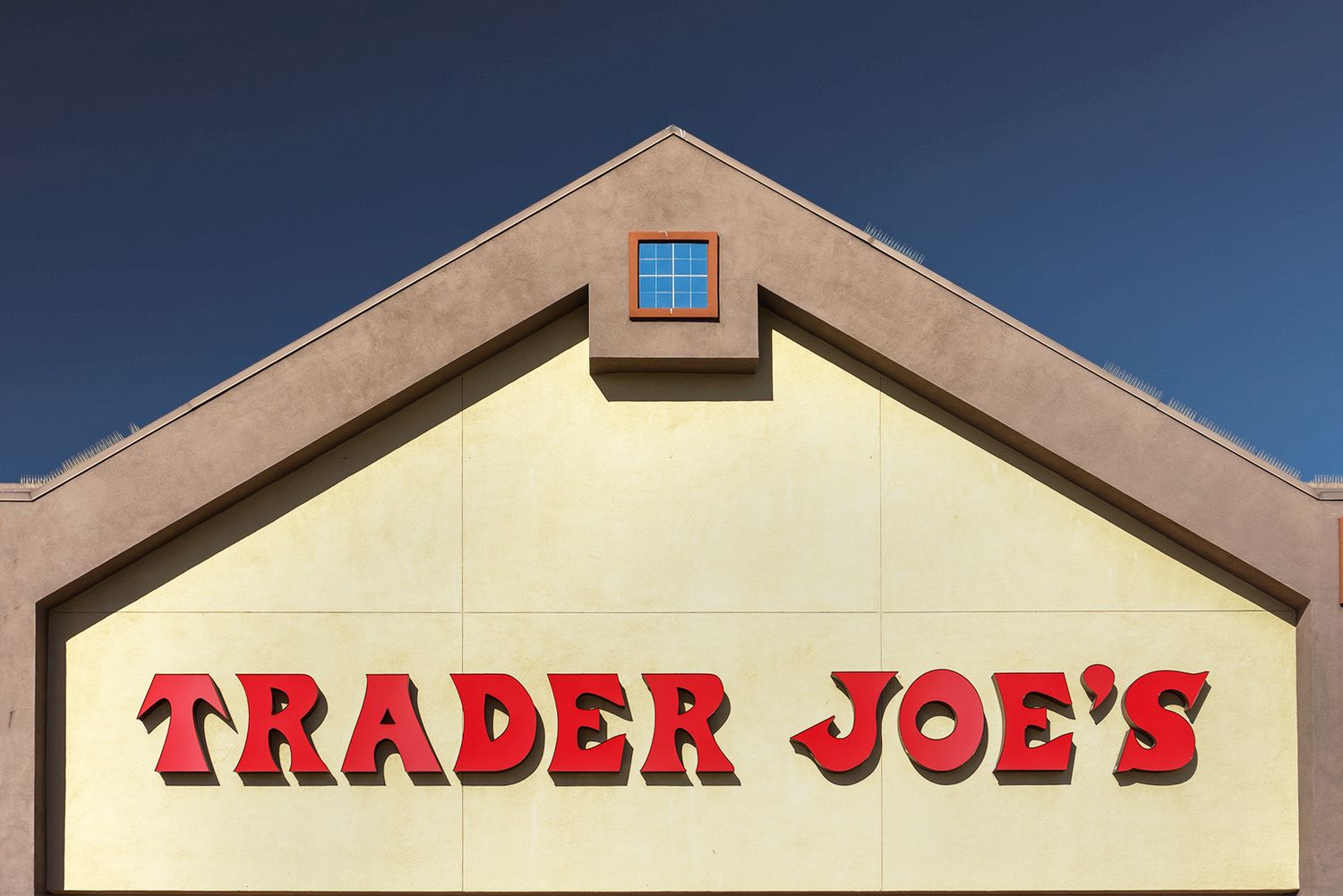 Trader Joes storefront gablestyle facade with brand name prominently displayed