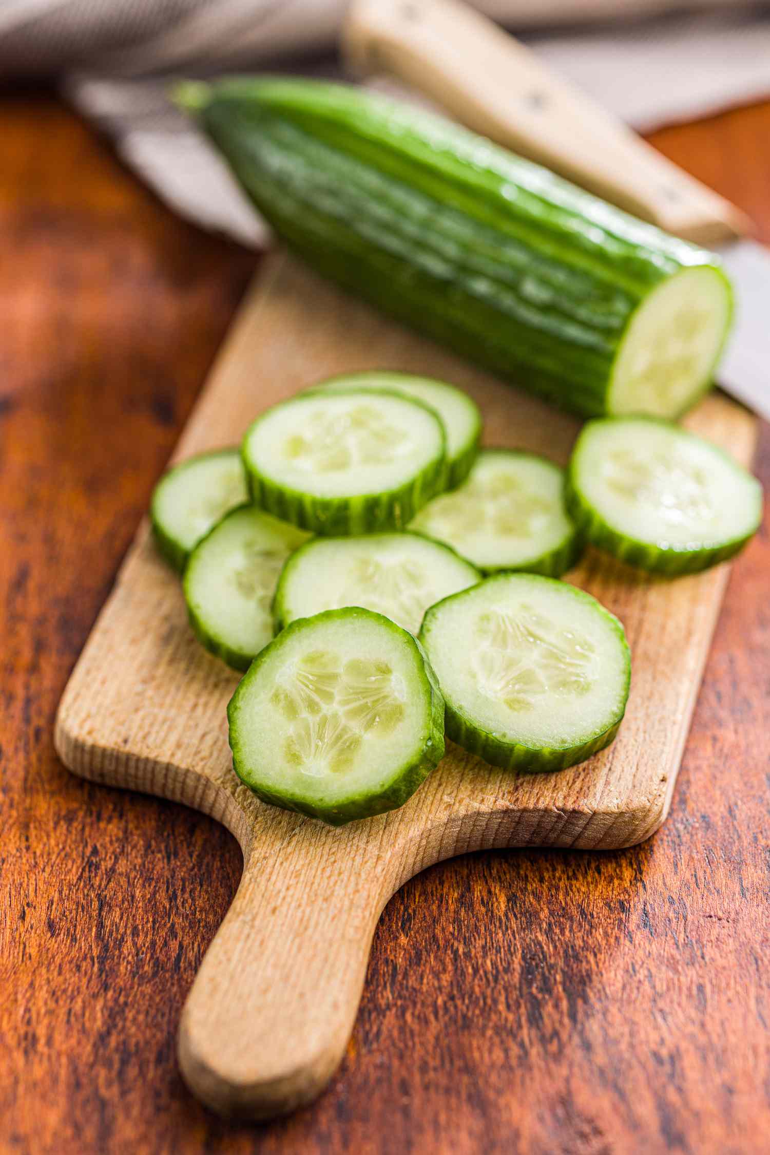 Sliced cucumber on a wooden cutting board