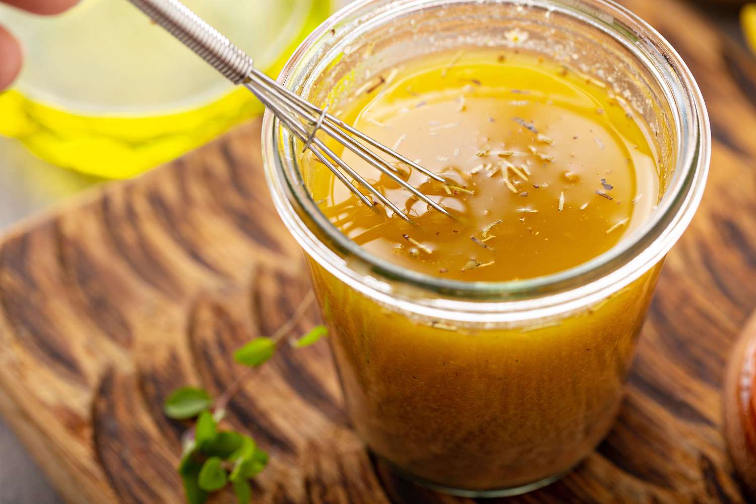 Jar of salad dressing with a small whisk