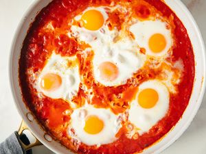Skillet with eggs cooked in a tomatobased sauce a dish known as eggs in purgatory