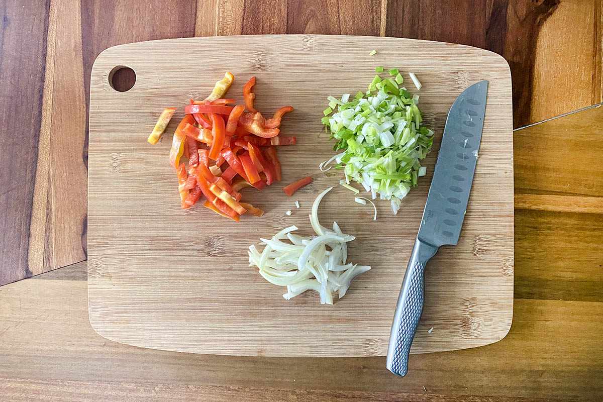 Fresh ingredients sliced on a cutting board for a Jamaican Stewed Beef Recipe.