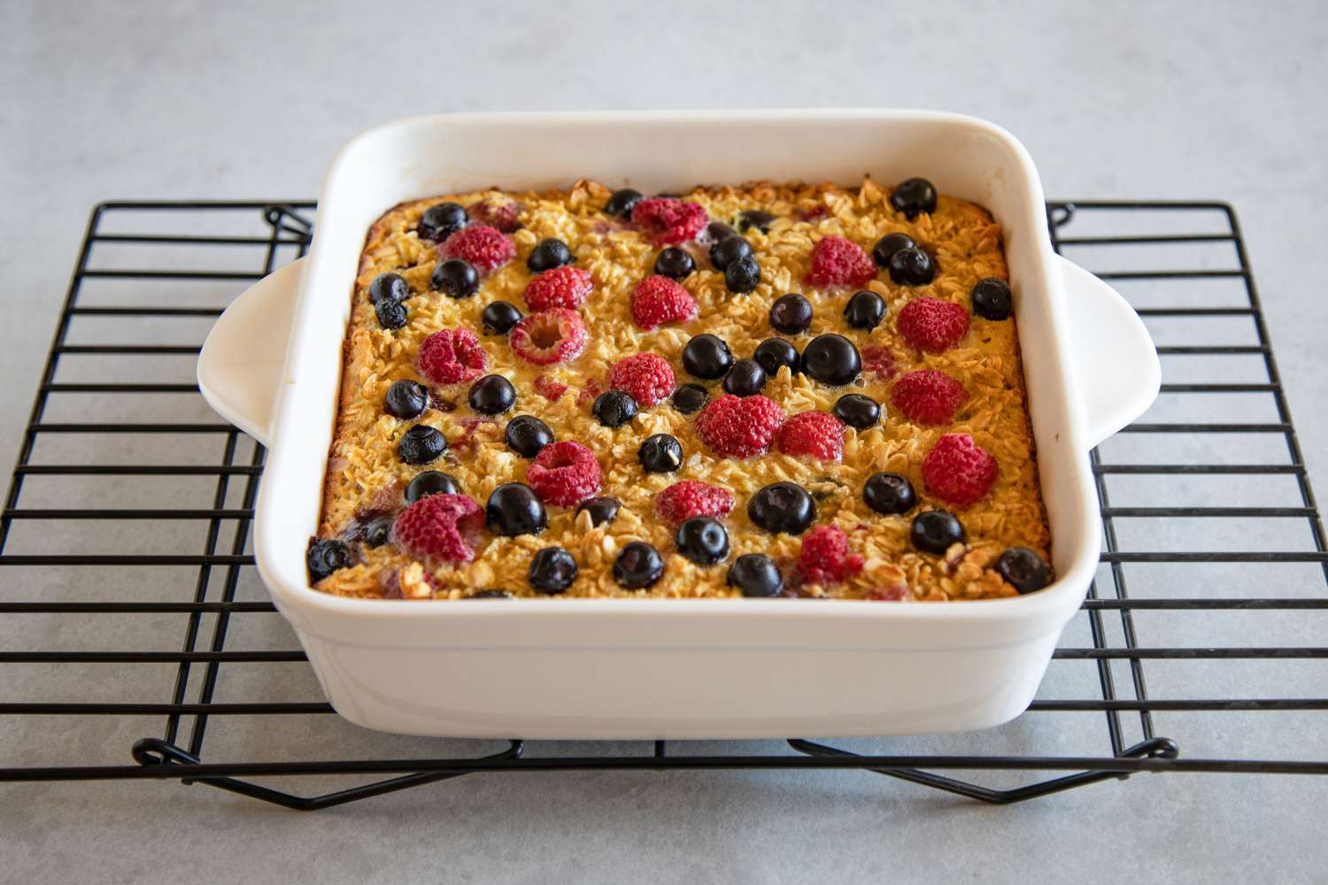 Mixed Berry Baked Oatmeal (Gluten-Free) cooling on a wire rack.