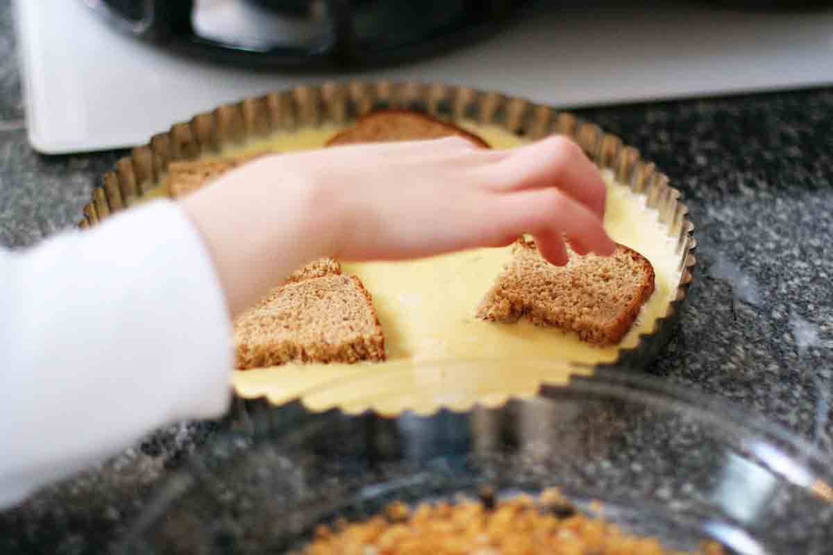 dipping toast squares into egg batter