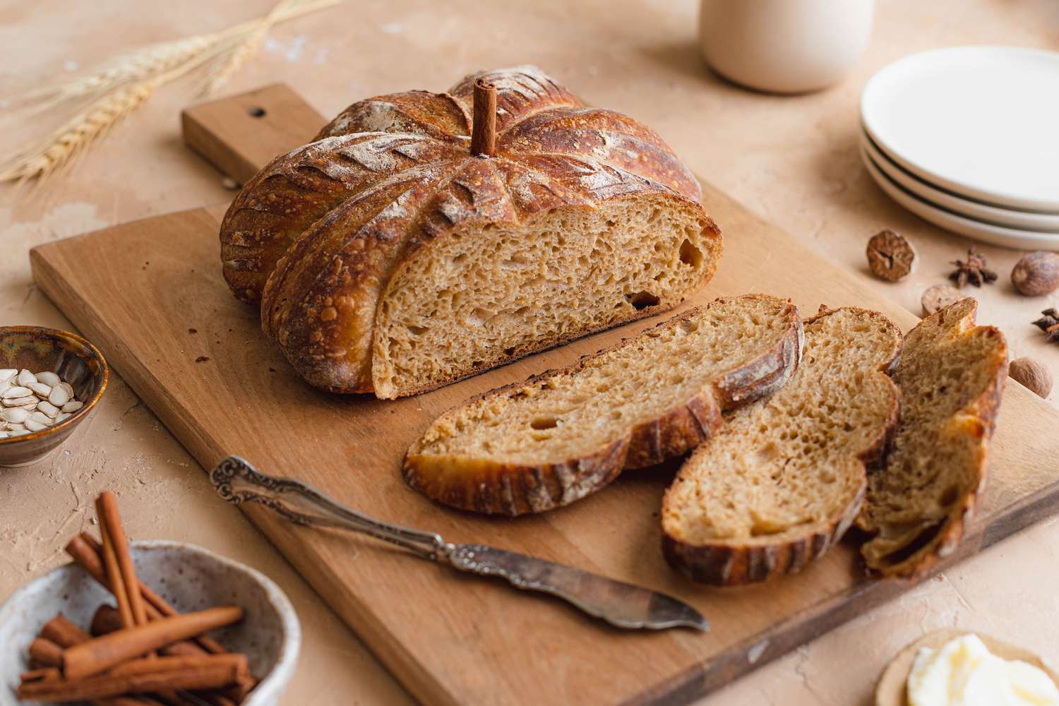 Pumpkin-shaped sourdough on a cutting board and cut into slices.