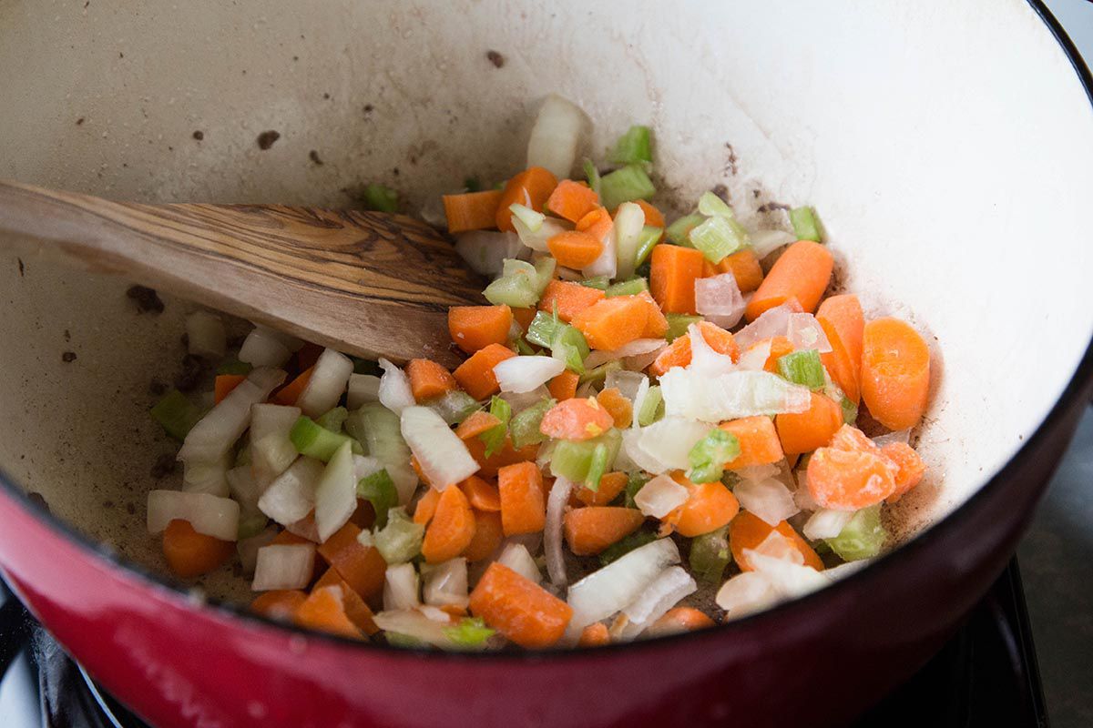 Sautéing carrots, onion, and celery in a Dutch oven