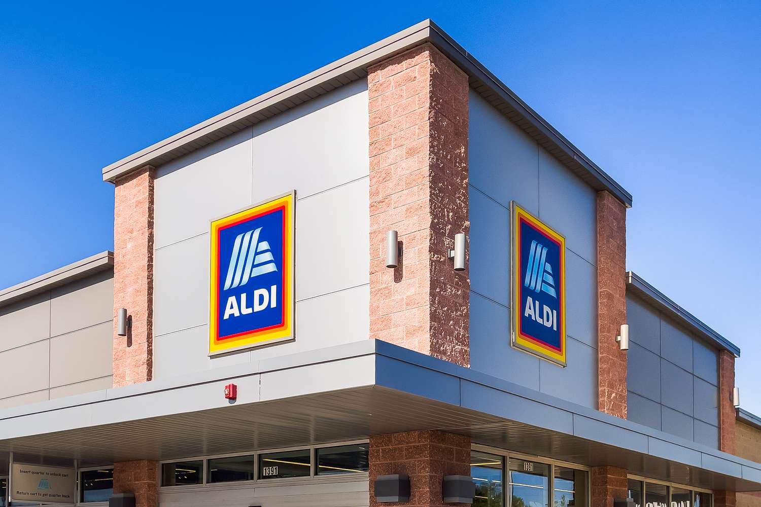 Exterior view of an ALDI grocery store building, featuring the ALDI logo on its facade