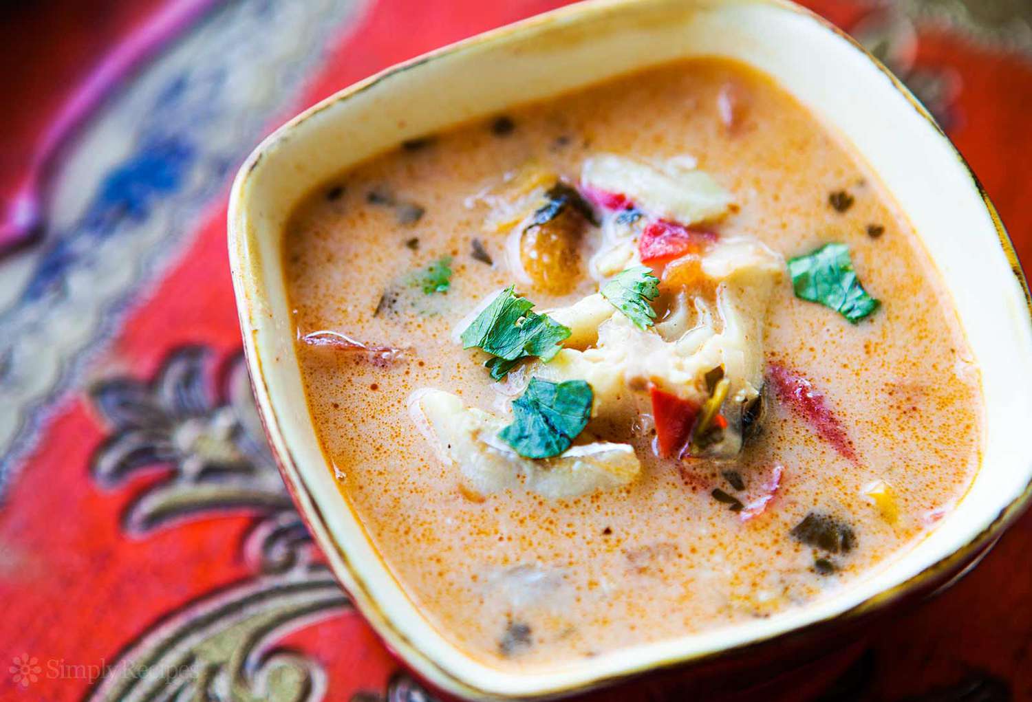 A bowl of moqueca garnished with parsely
