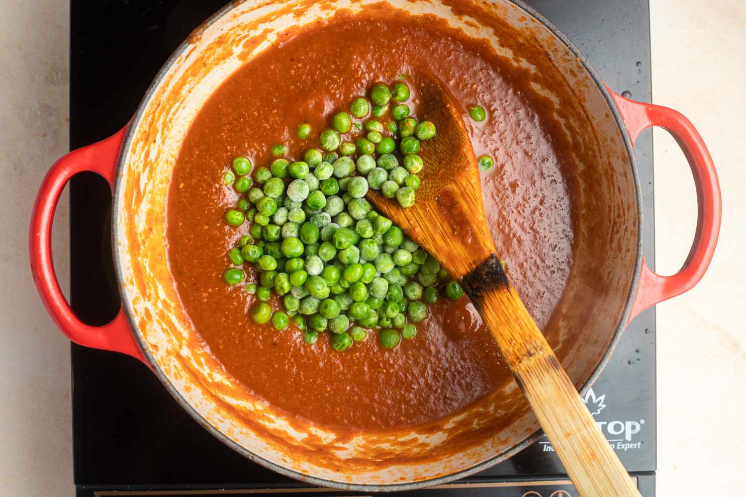 Add peas to sauce for matar paneer 