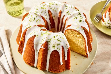 7UP bundt cake on a plate at a table setting with a glass of soda and a plate with a serving 