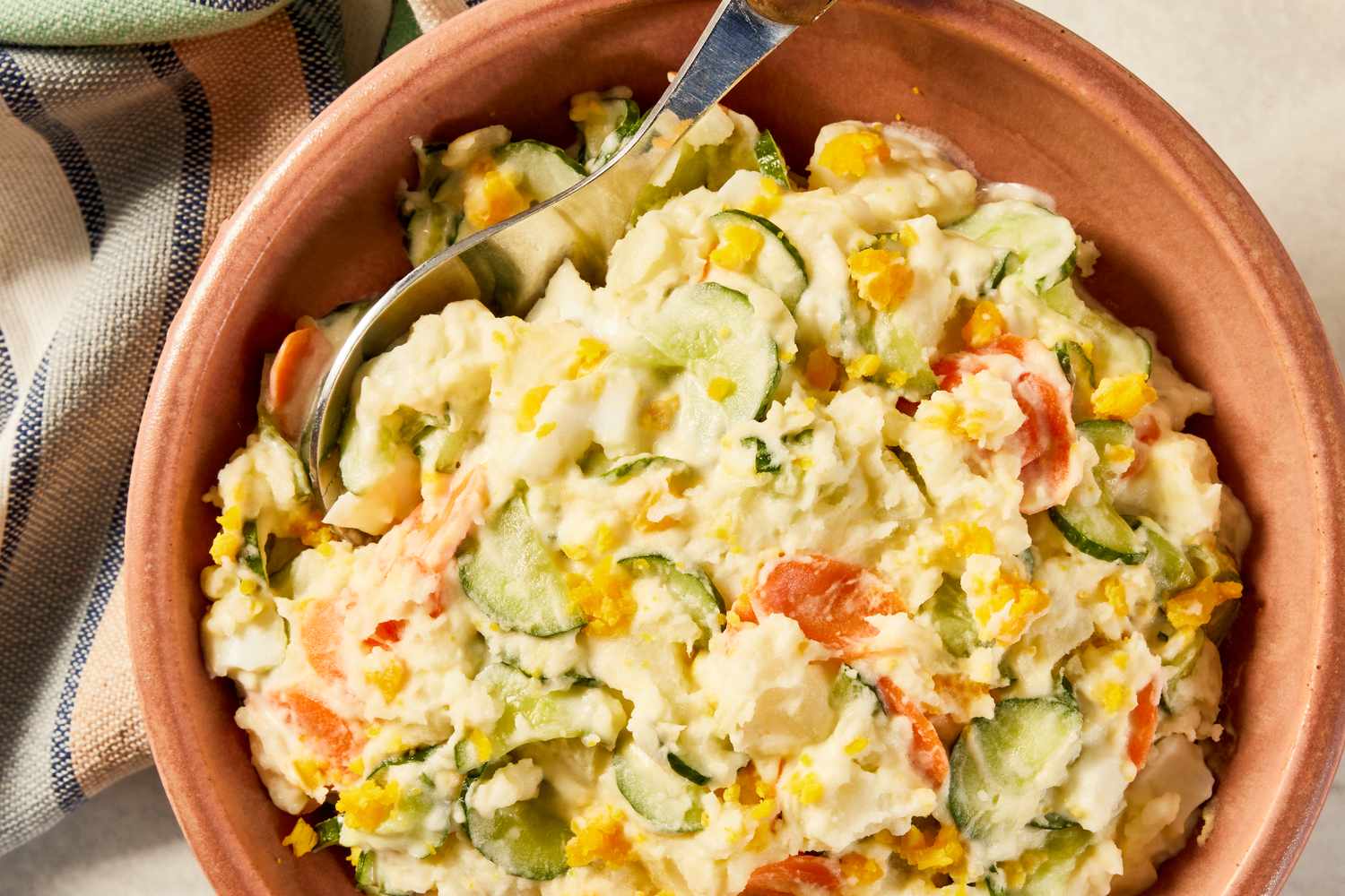 Korean-style potato salad in a bowl next to a table napkin