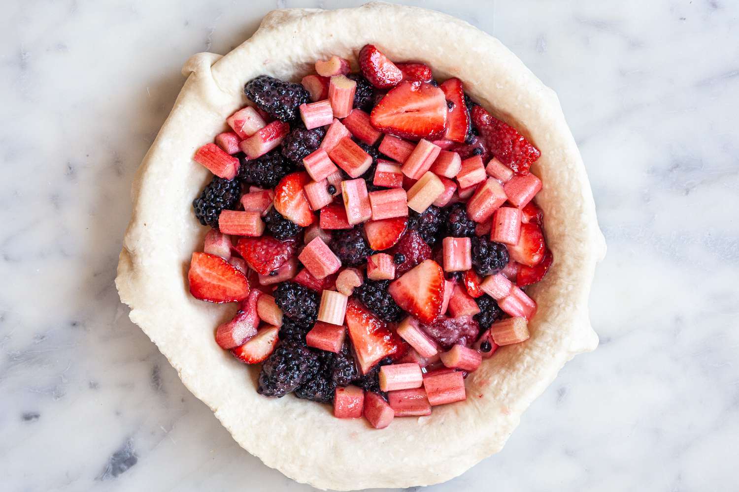 Filling the pie with fruit filling to make a lattice pie.