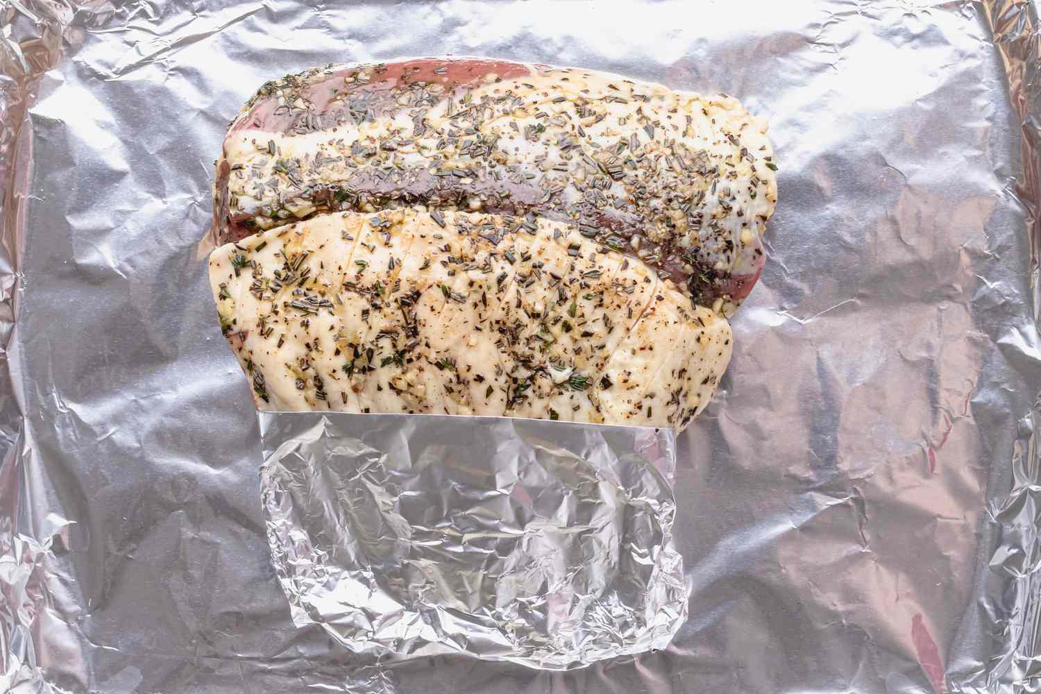 Method shot - raw rack of lamb on aluminum foil 