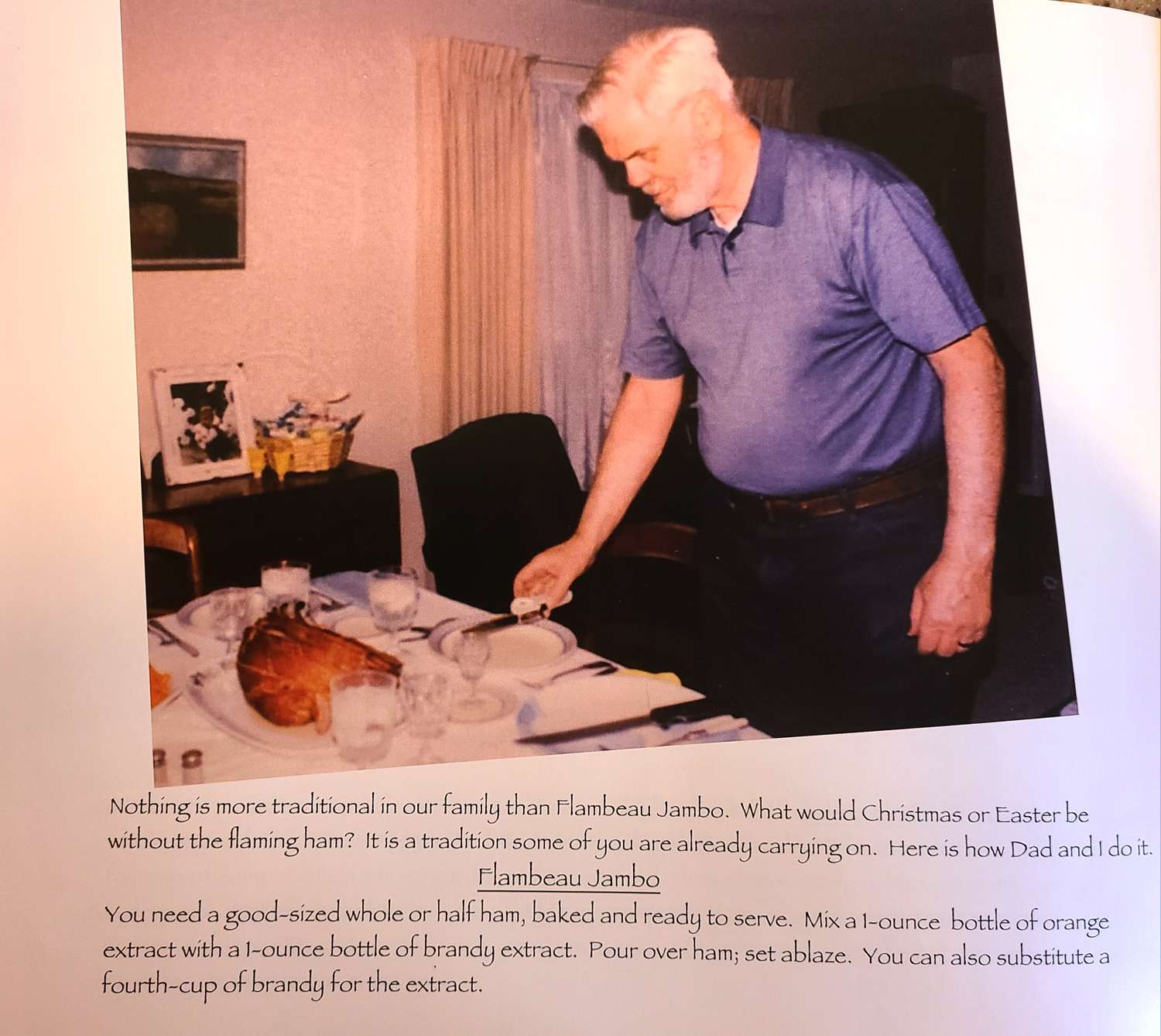A man standing near a table with a cooked ham on a plate and table settings
