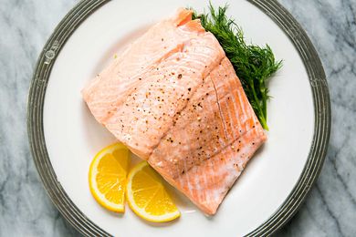 Poached Salmon with dill on a plate with silver trim