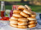 Stack of sesame hamburger buns on a plate outdoors