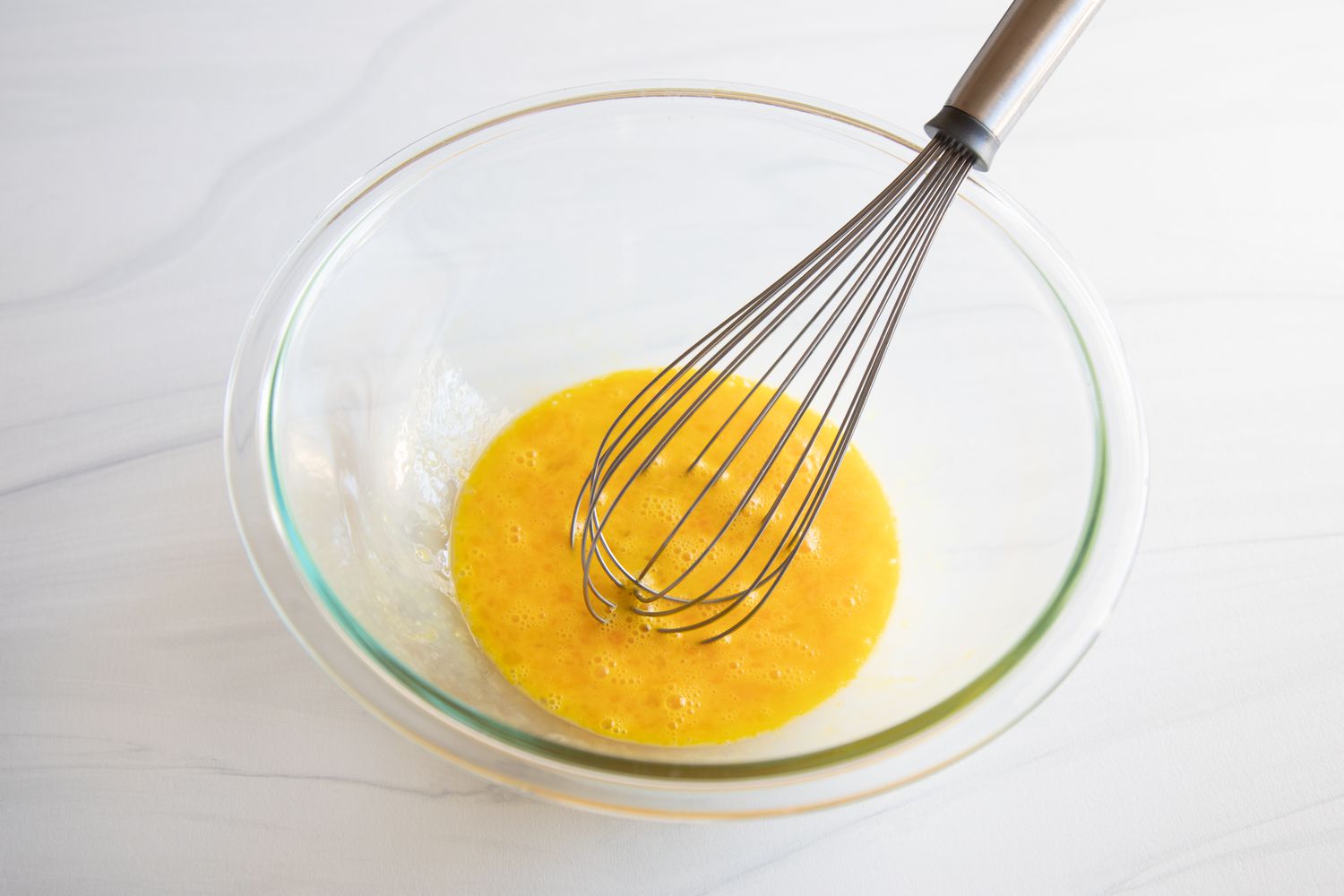 Whisking eggs to make a Southern Peanut Pie.