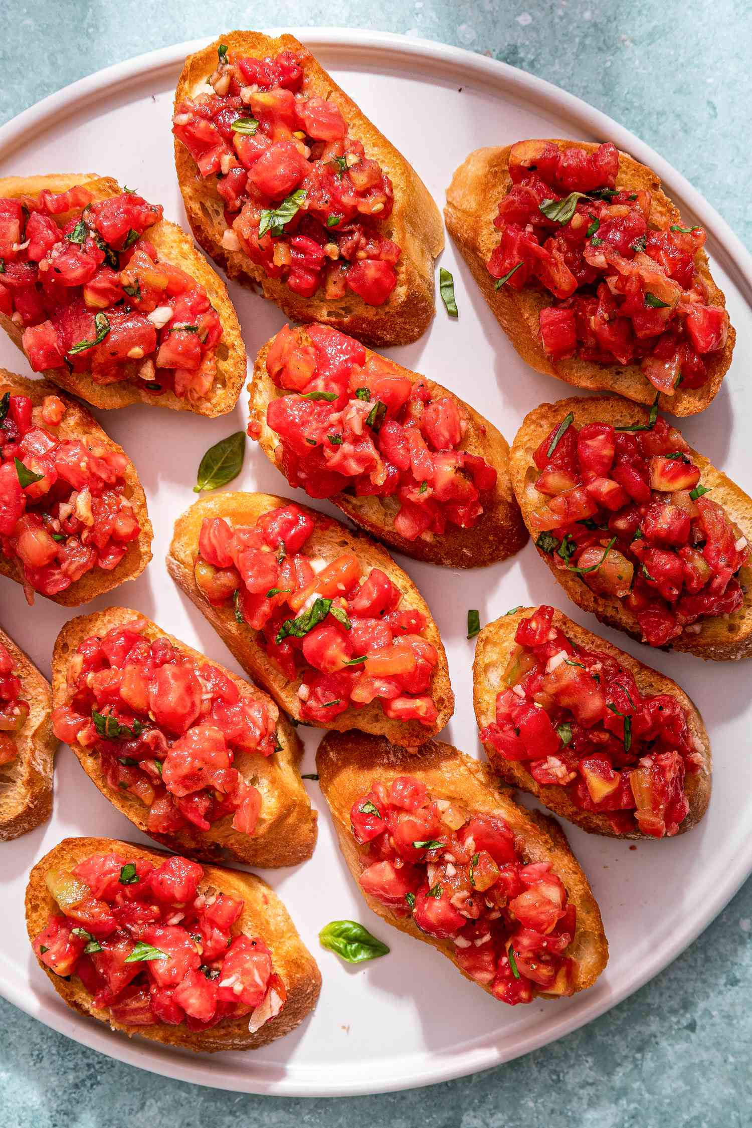 Overhead photo of bruschetta with tomato and basil on a plate