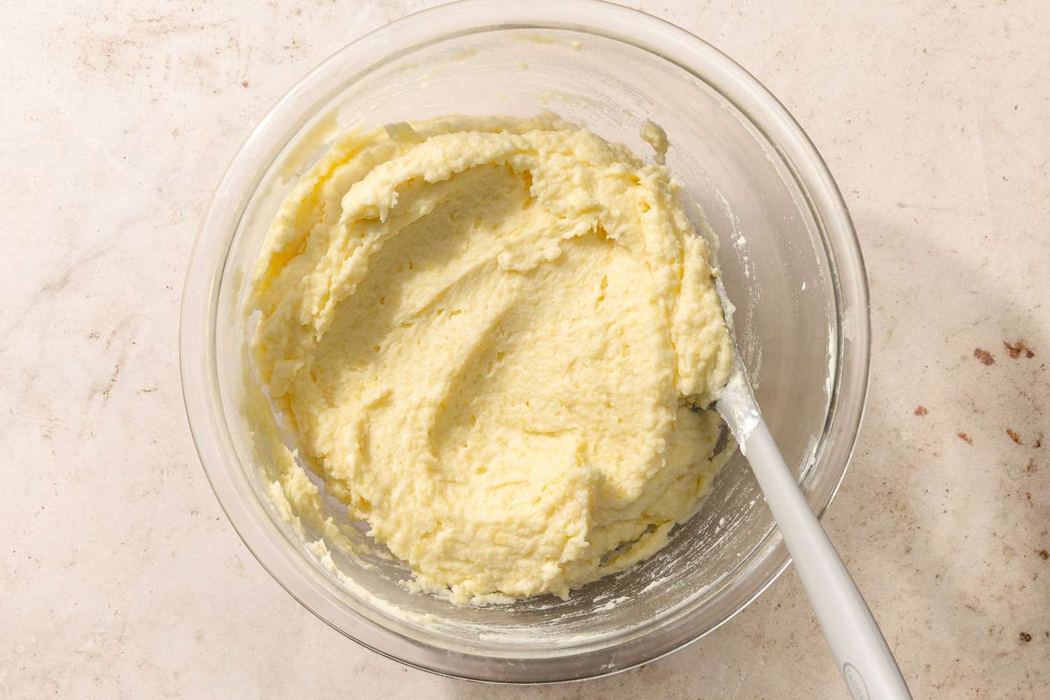 potato mixture in a bowl with a spatula for Chantilly Potatoes