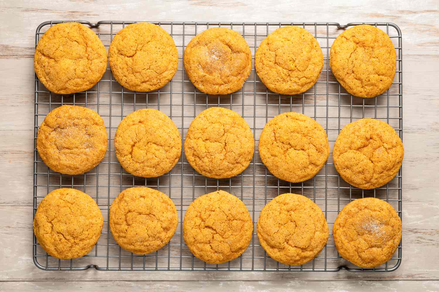 Pumpkin spice snickerdoodle cookies cooling on a wire rack