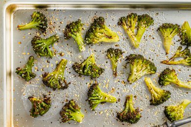 roasted, seasoned broccoli florets on a sheet pan