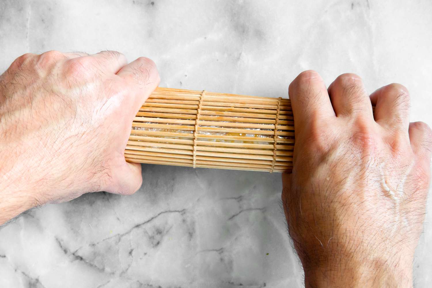 Sushi Mat Tightened Around California Roll