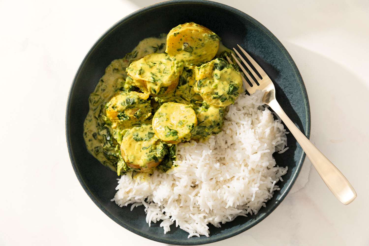Bowl of 5-Ingredient Curried Potatoes with jasmine rice