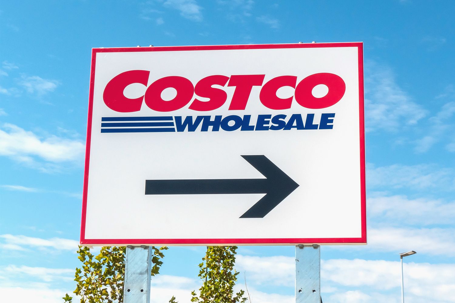 Costco Wholesale directional sign showing a rightpointing arrow