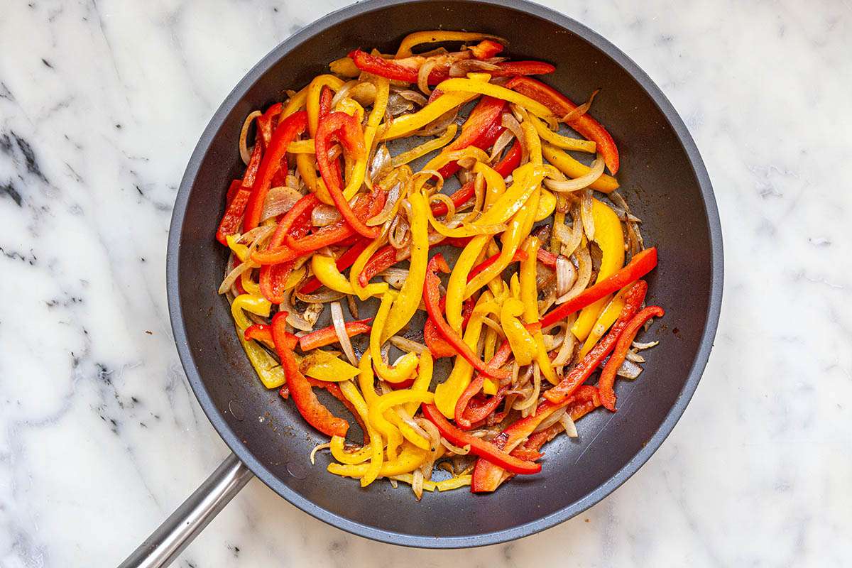 How to Make Shakshuka by sauteeing peppers in a pan.