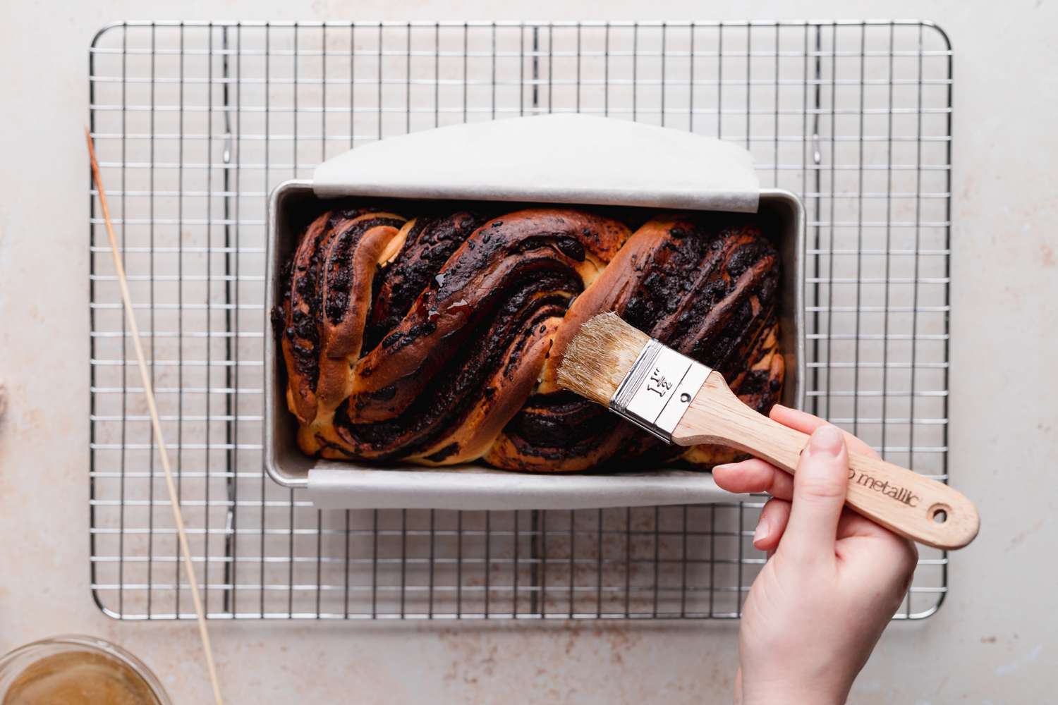 Brushing syrup on chocolate babka.