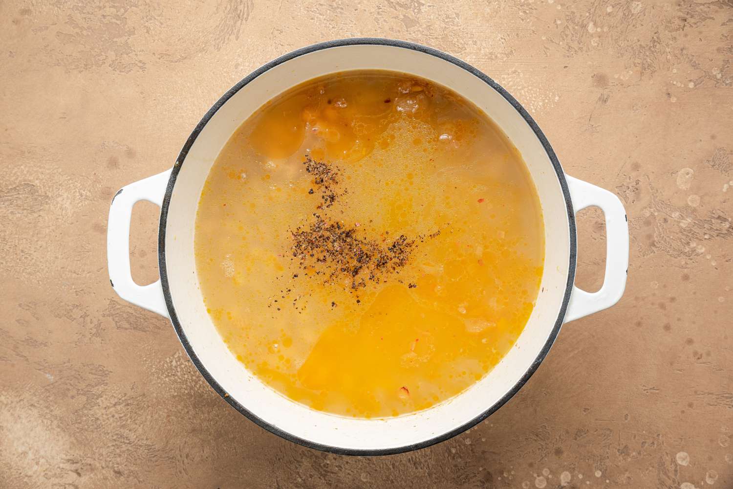 Seasoning Added to Pot of Creamy White Bean Soup