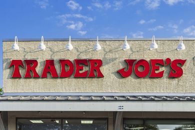 Trader Joes storefront sign wallmounted featuring the name in red letters