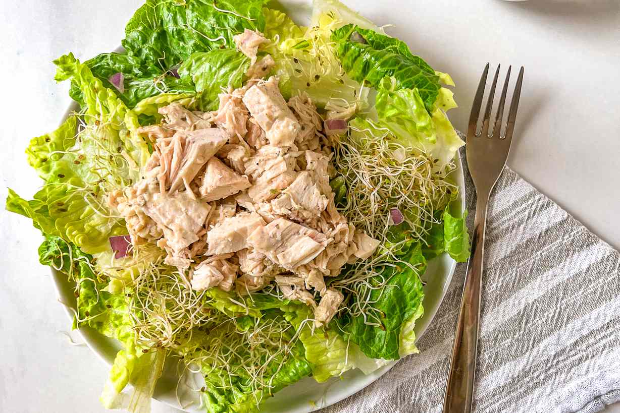 2-ingredient chicken salad over a bed of microgreens and lettuce