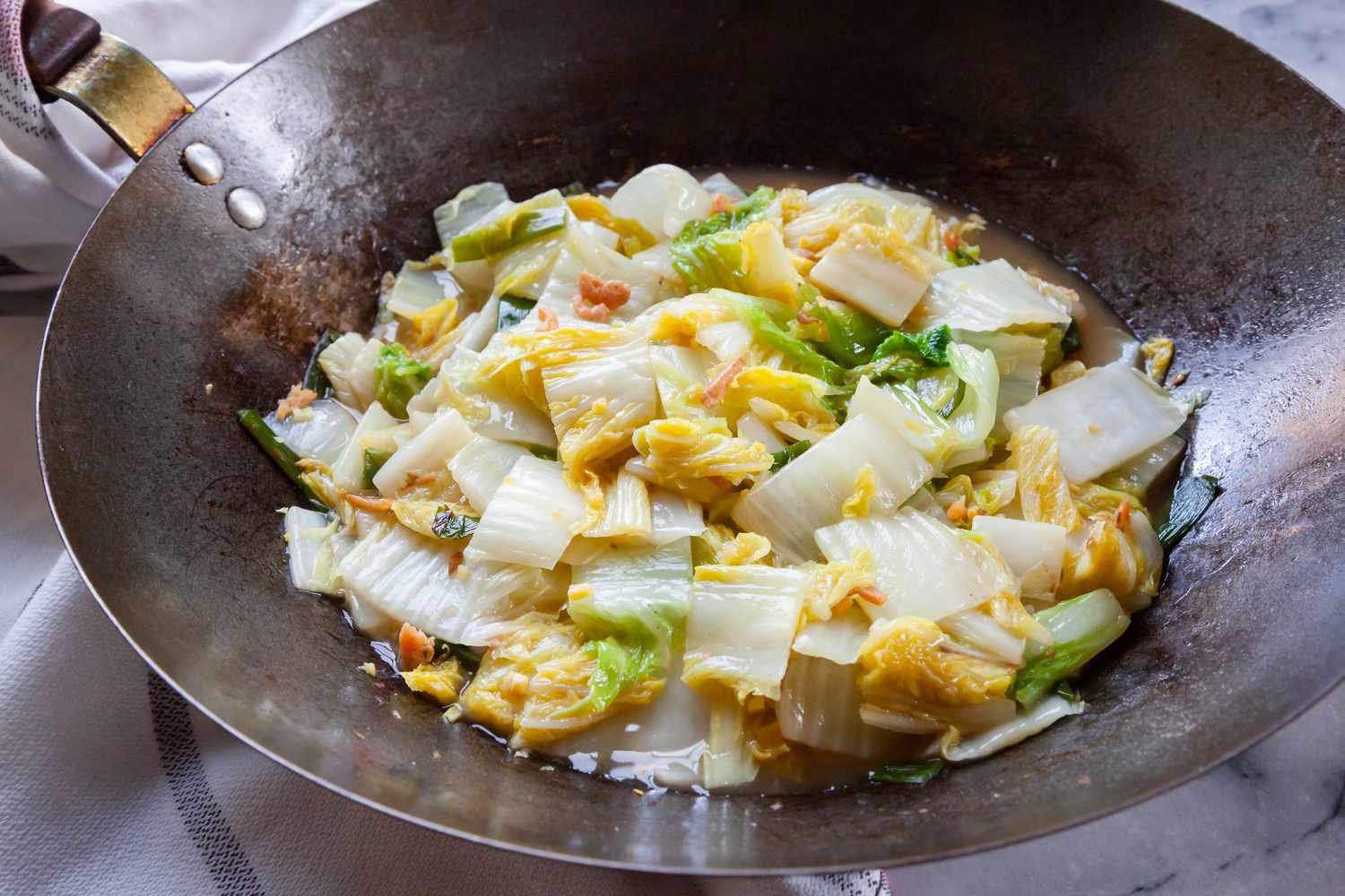 Napa Cabbage with Dried Shrimp cooked in a wok.
