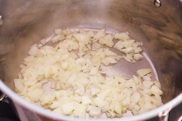 Onions sautéing in a stock pot 