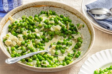 Creamed Peas in a bowl with a spoon